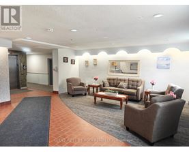 A waiting area with a couch, chairs, and a coffee table.