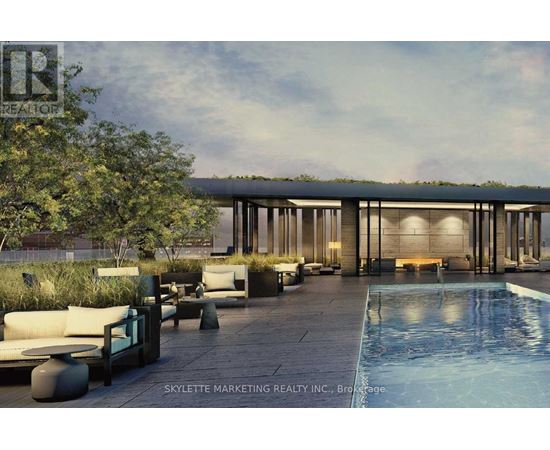A modern outdoor seating area with a pool and a building in the background.