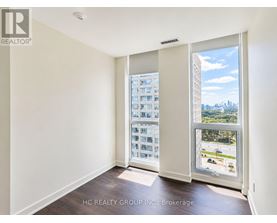 A room with a view of a cityscape through a large window.