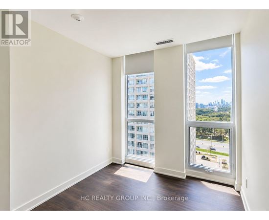 A room with a view of a cityscape through a large window.