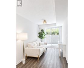 A bedroom with a large bed and a window overlooking a fence.