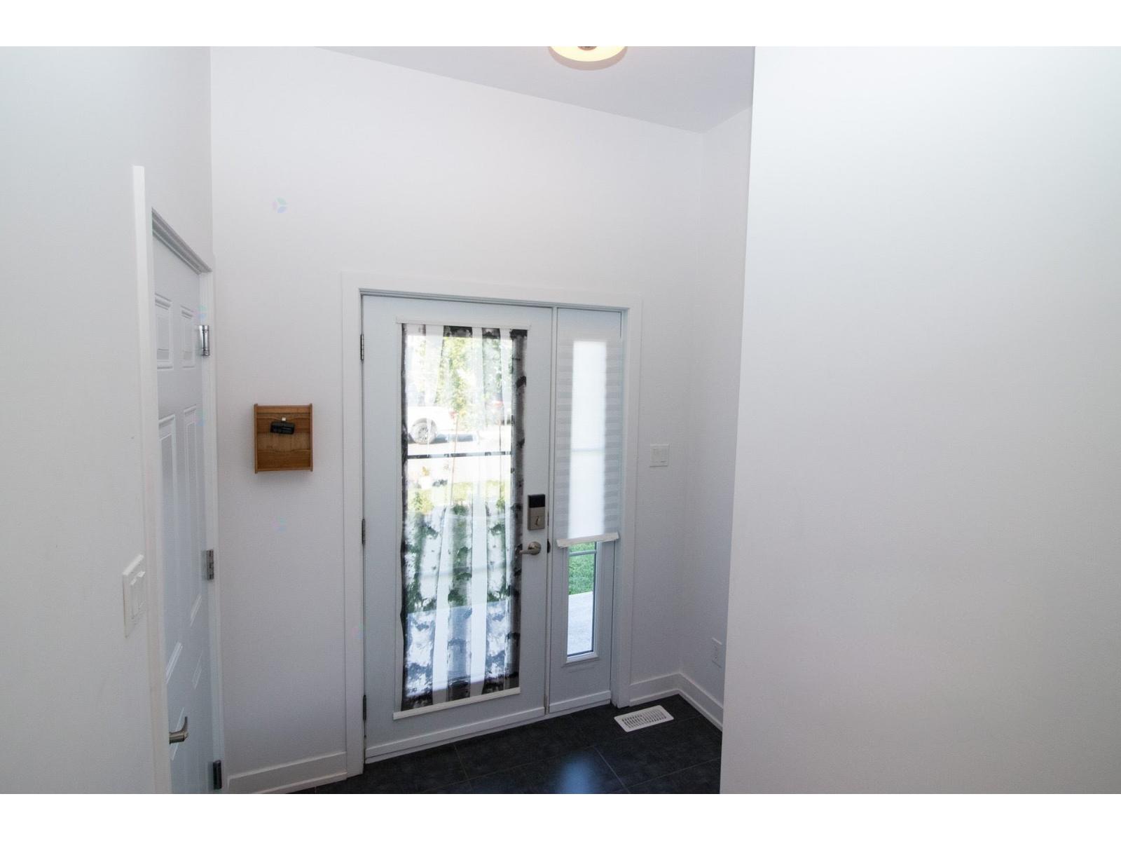A white door with a window in the background.