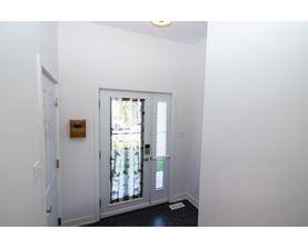 A white door with a window in the background.