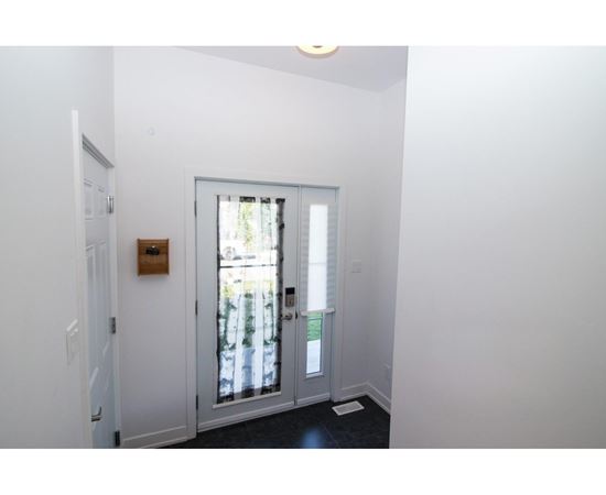 A white door with a window in the background.
