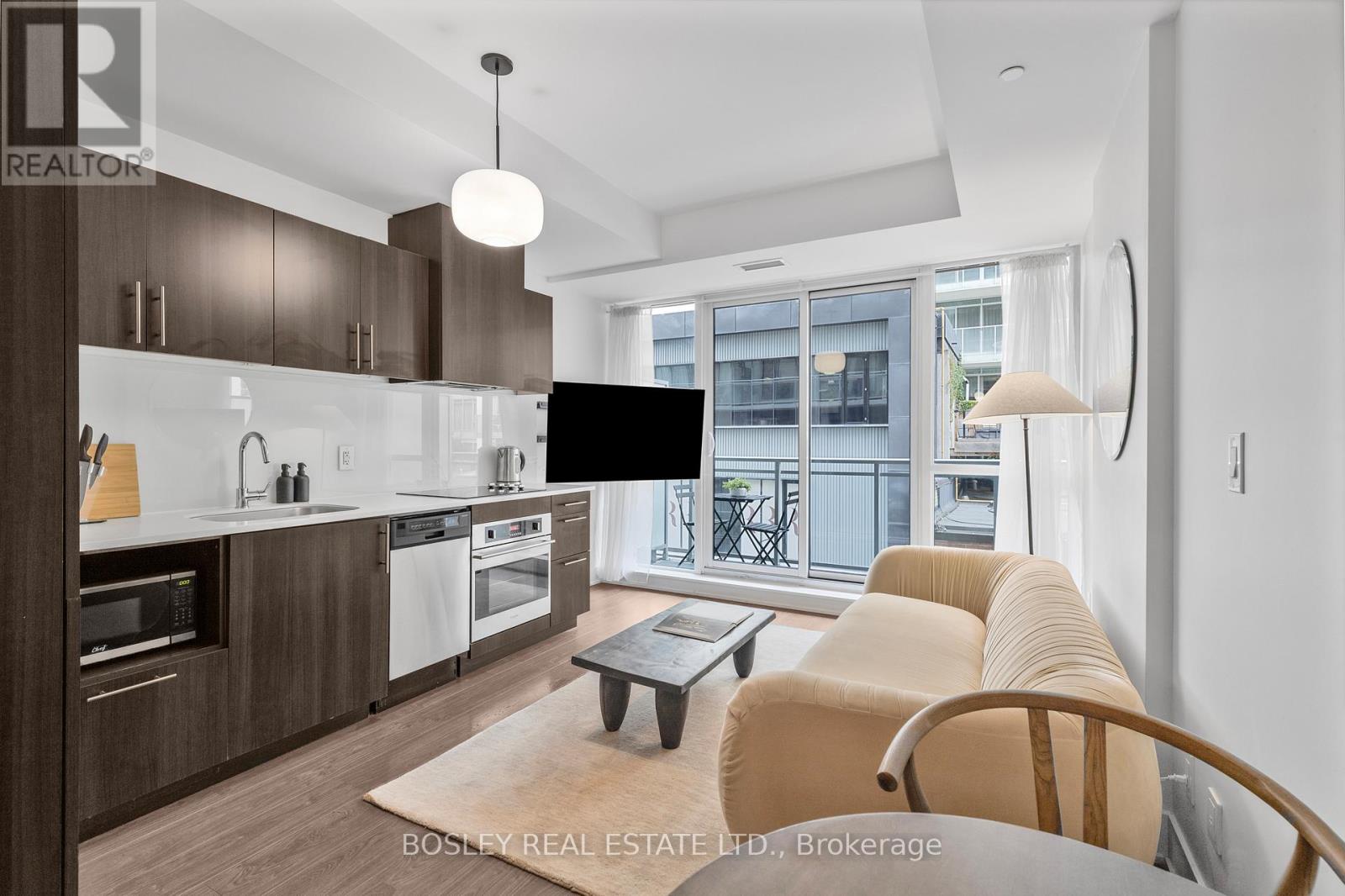 A modern kitchen with a dining table and chairs.