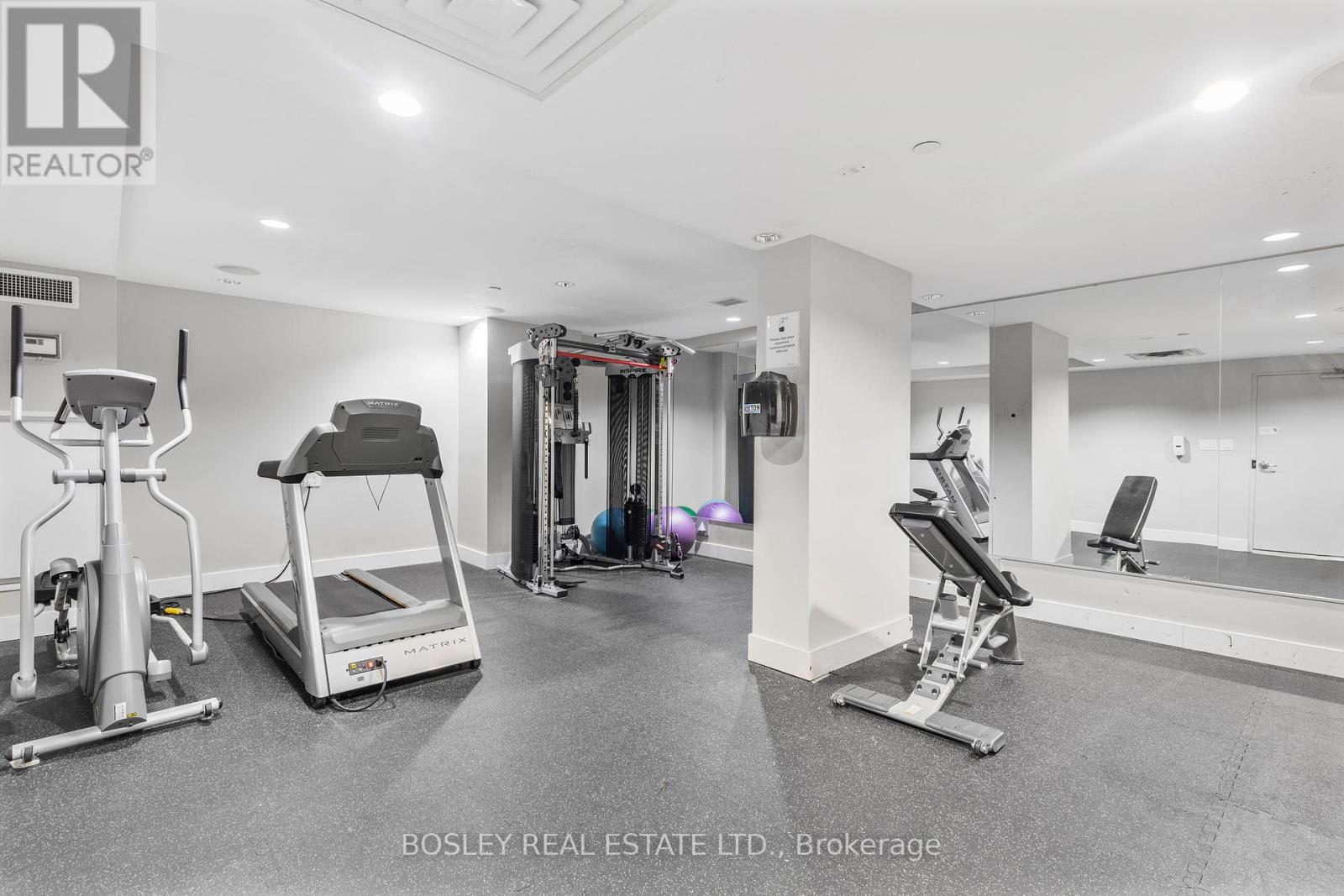 A spacious home gym with a variety of exercise equipment.
