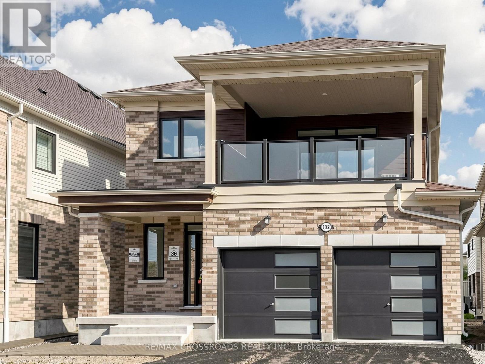 A modern house with a garage is for sale.