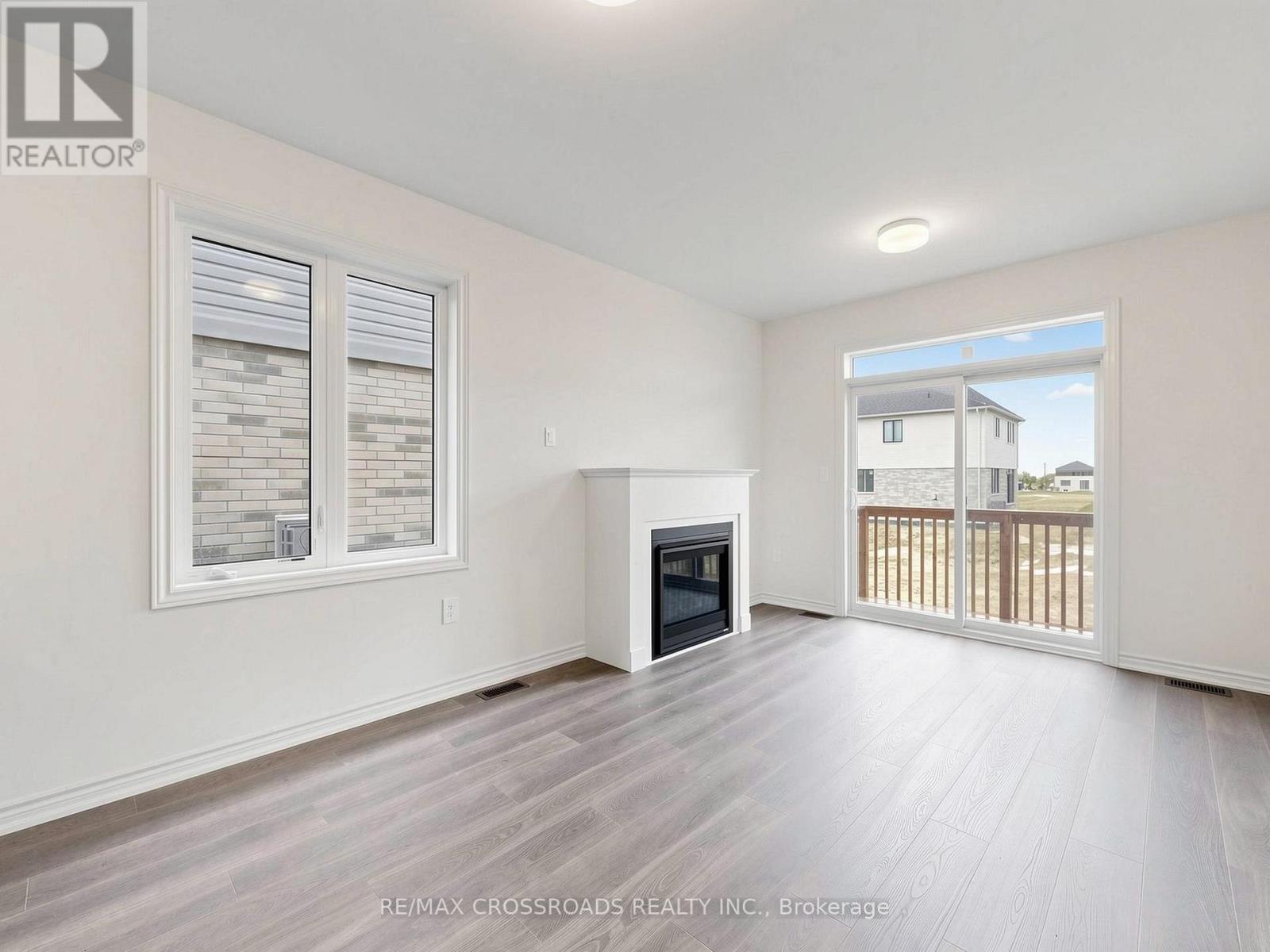 A spacious living room with a fireplace and sliding glass doors.
