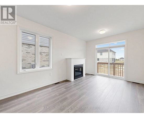 A spacious living room with a fireplace and sliding glass doors.