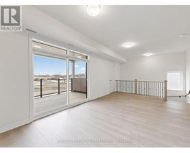 A spacious room with a sliding glass door leading to a balcony.