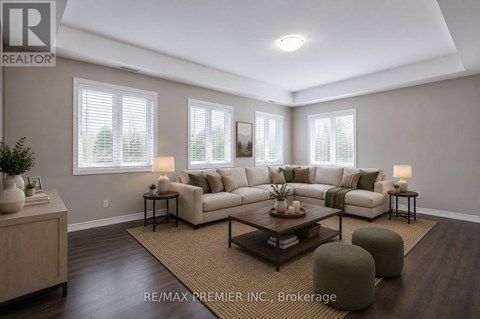 A well-lit living room with a large sectional sofa and a coffee table.