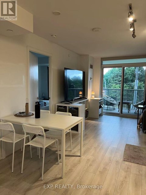 A dining room with a table and chairs.