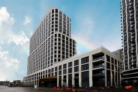 A modern building with a rainbow in the sky.