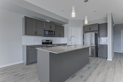 A modern kitchen with a large island in the center.