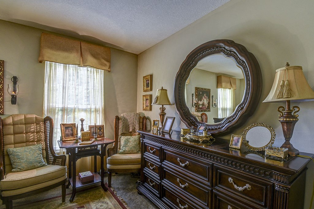 a living room with a dresser and a mirror