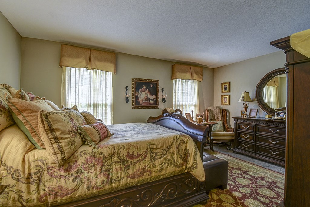 a bedroom with a bed and a dresser