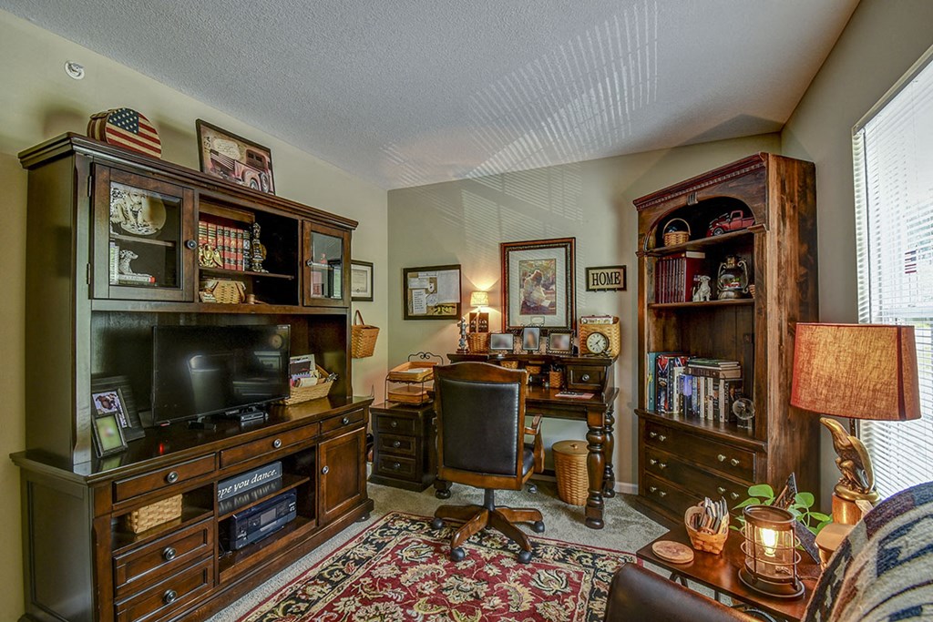a living room filled with furniture and a tv