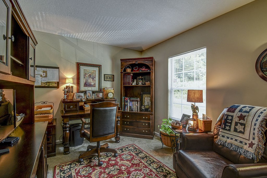 a living room filled with furniture and a window