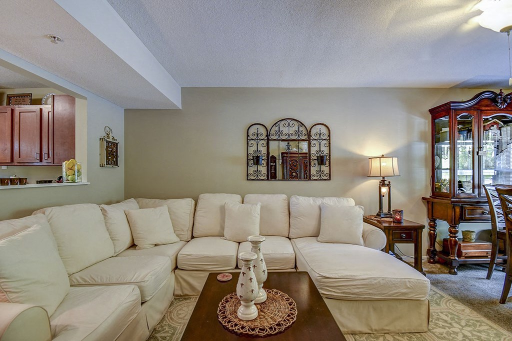 a living room with white couches and a coffee table