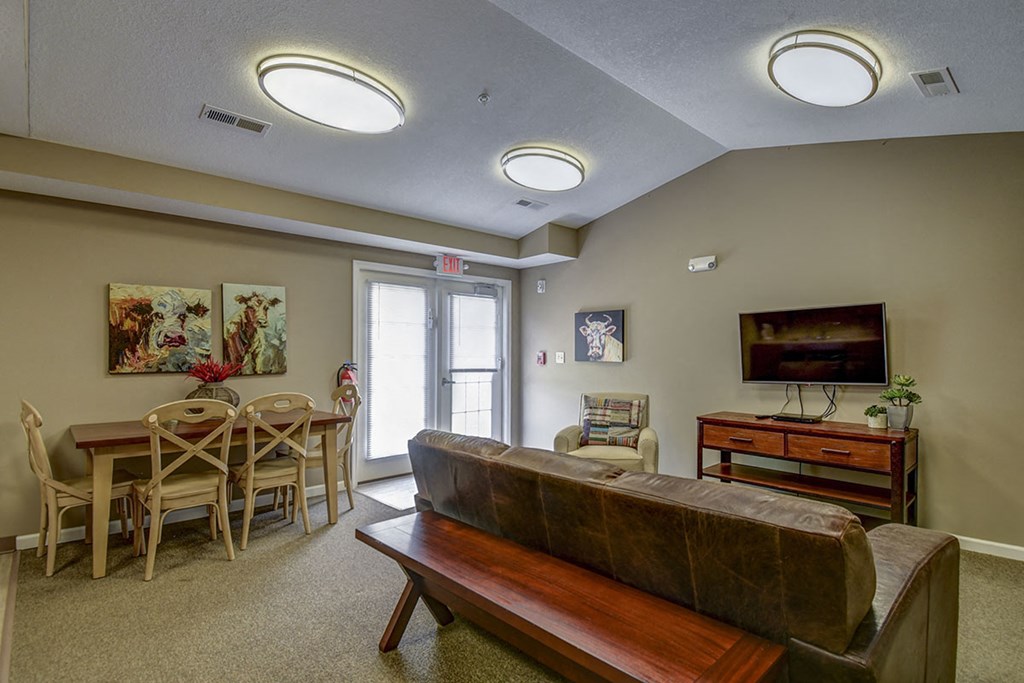a living room with a couch and a table with chairs