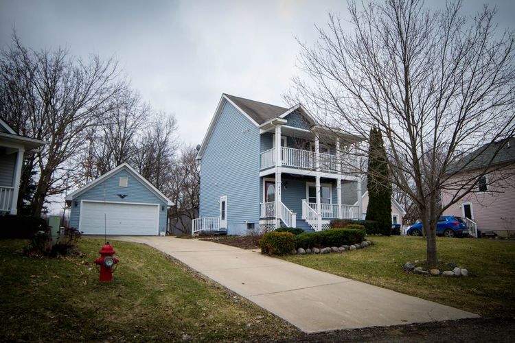 A blue house with a red fire hydrant in front of it.