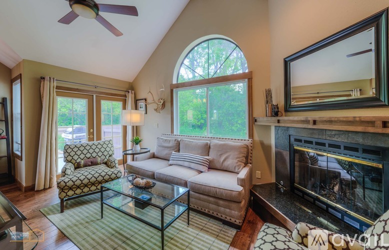 A living room with a fireplace and a television.