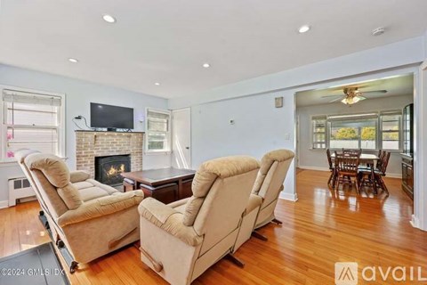 A living room with two recliner chairs and a fireplace.