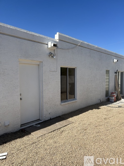 A white building with a door and window.