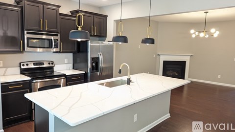 A kitchen with a white island in the middle of it.