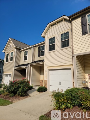 A two-story house with a garage is for sale.