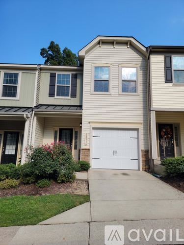 A house with a white garage door is for sale.