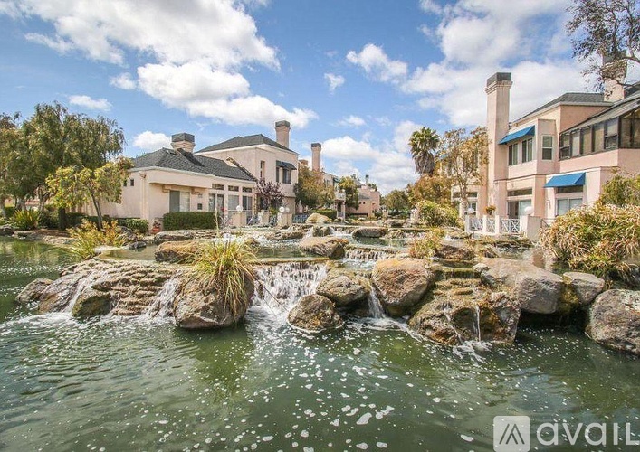 A house with a waterfall in front of it.