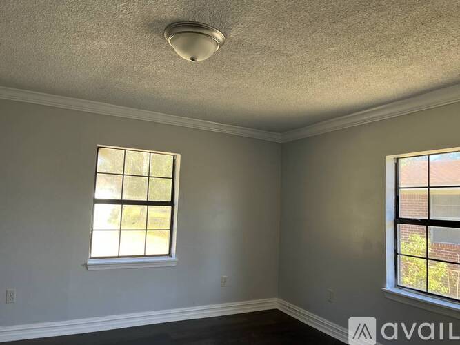 A room with two windows and a text "AVAIL" on the bottom right.