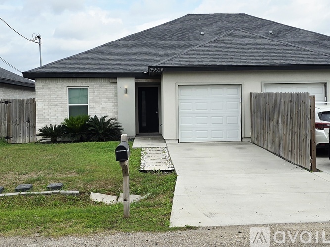 A house with a white garage door is for sale.