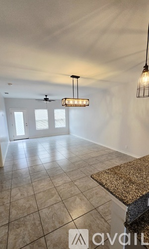 A room with a ceiling fan and a hanging light fixture.