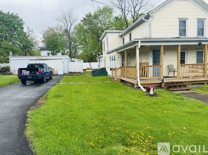 A house with a car parked in front of it.