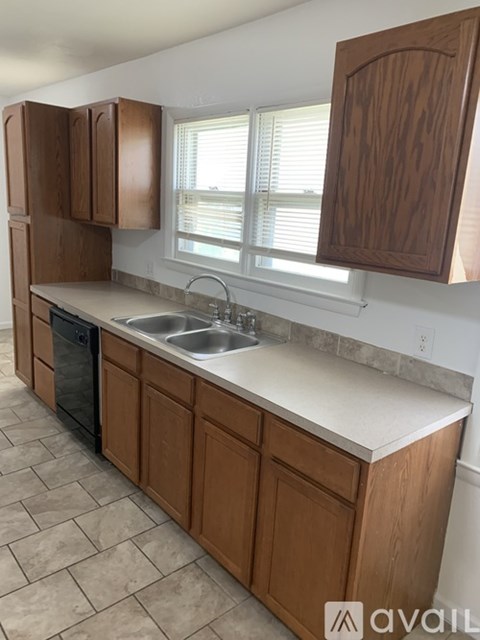 A kitchen with wooden cabinets and a white countertop.