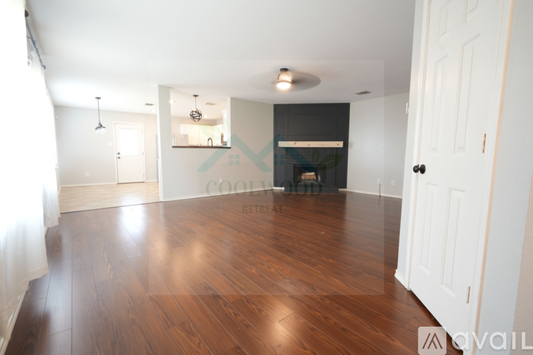 A room with wooden floors and white walls.