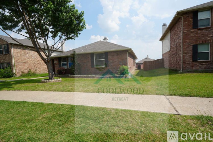 A house with a tree in front and a sign that says "AVAILABLE" on the grass.