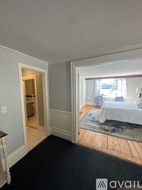 A bedroom with a bed and a window.
