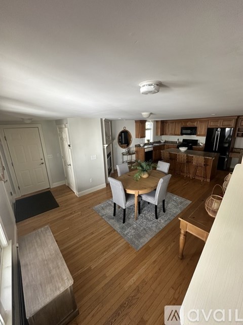 A kitchen with a dining table and chairs in the middle of the room.