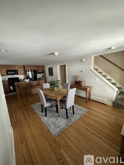 A dining room with a table set for four.