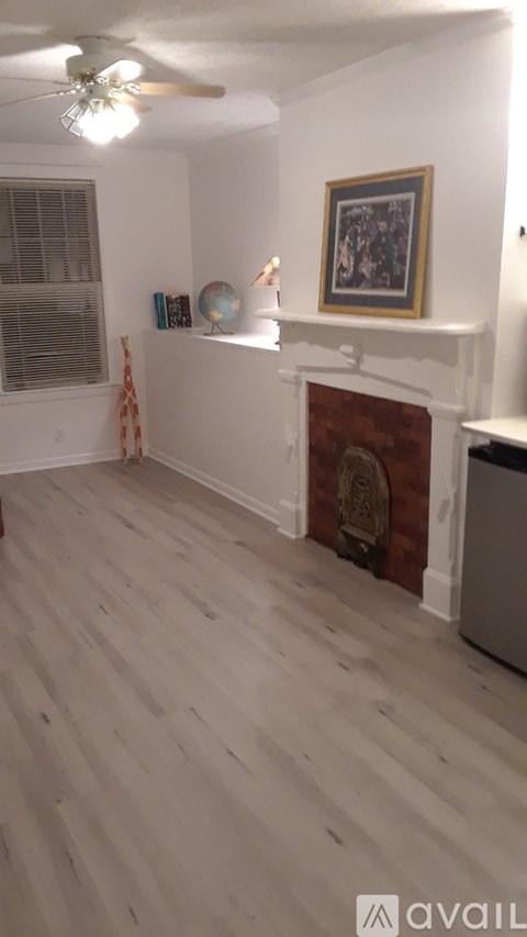 A room with a fireplace and a painting on the wall.
