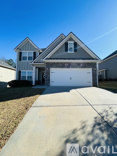 A house with a garage is for sale.