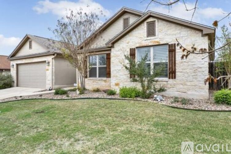 A house with a stone exterior and a garage door.