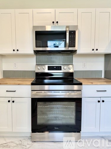 A modern kitchen with a stove and oven built into the cabinetry.