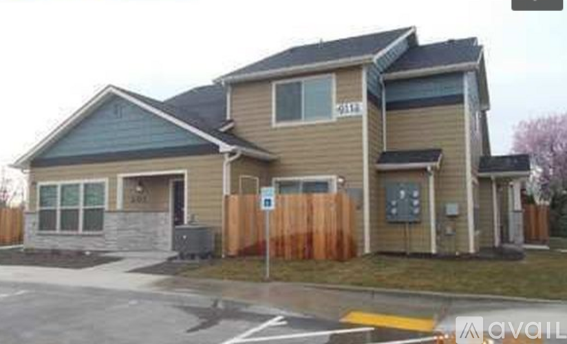 A two-story house with a garage and a driveway.