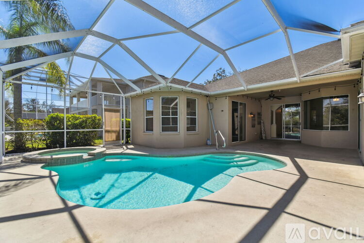 A house with a pool under a white roof.