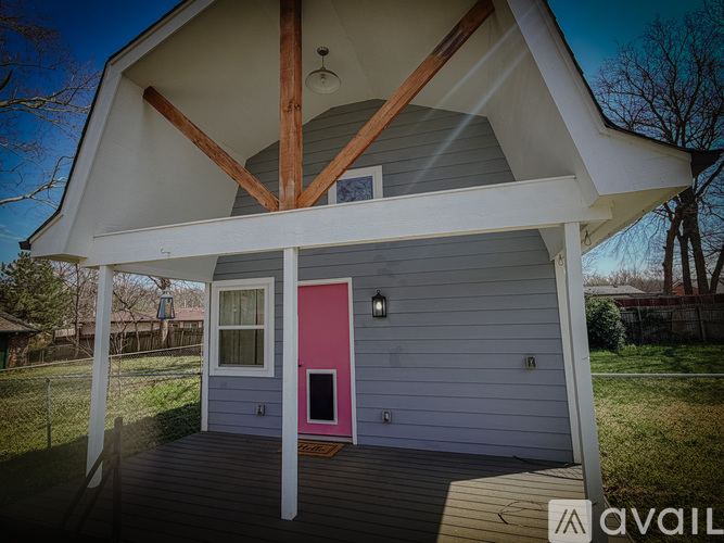 A house with a pink door is for sale.