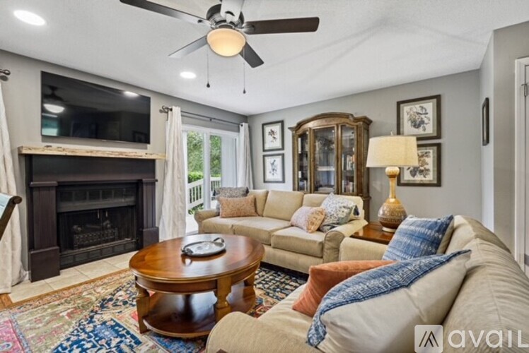 A living room with a fireplace, a couch, and a coffee table.